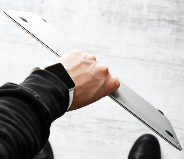 holding macbook